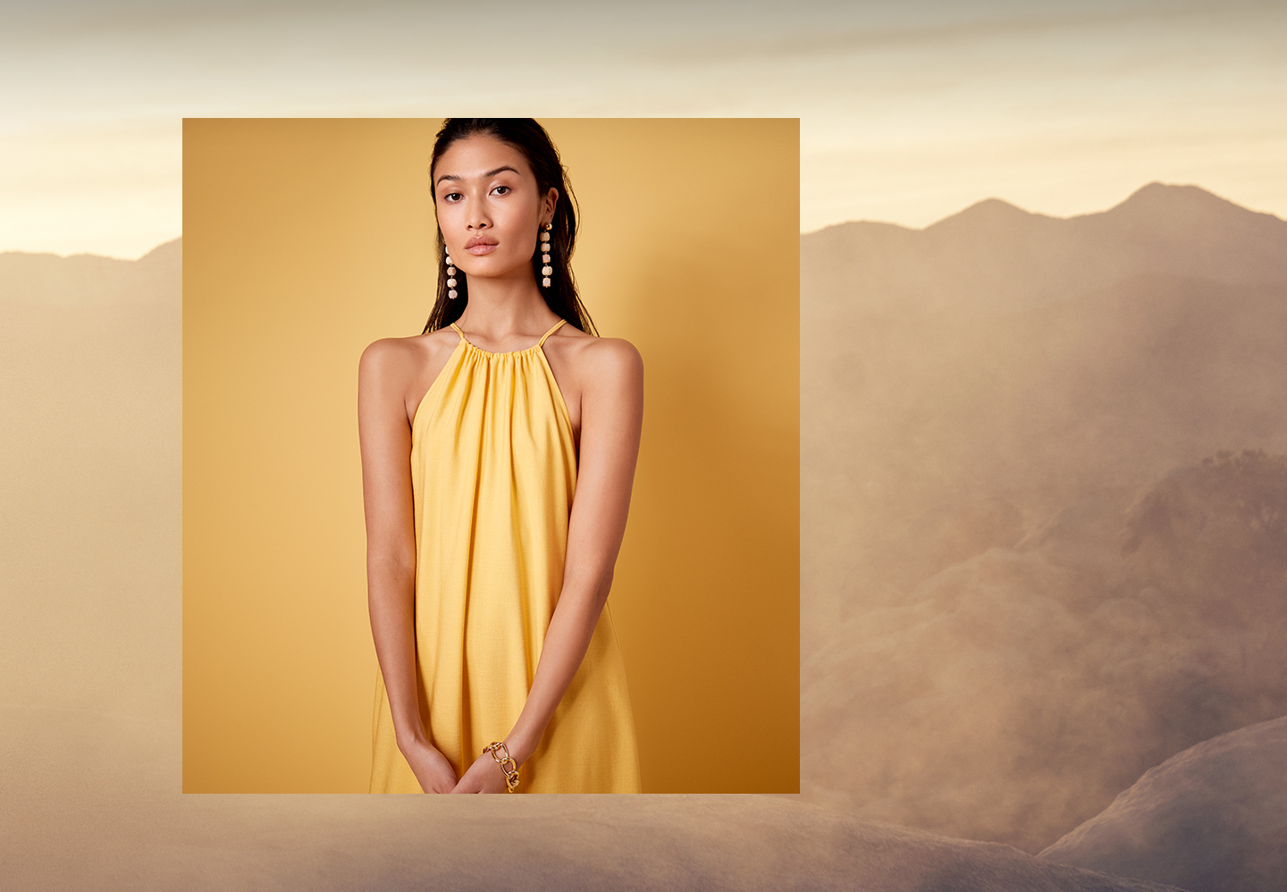 Campaign: Golden Hour. Background Image of woman in yellow dress with landscape background