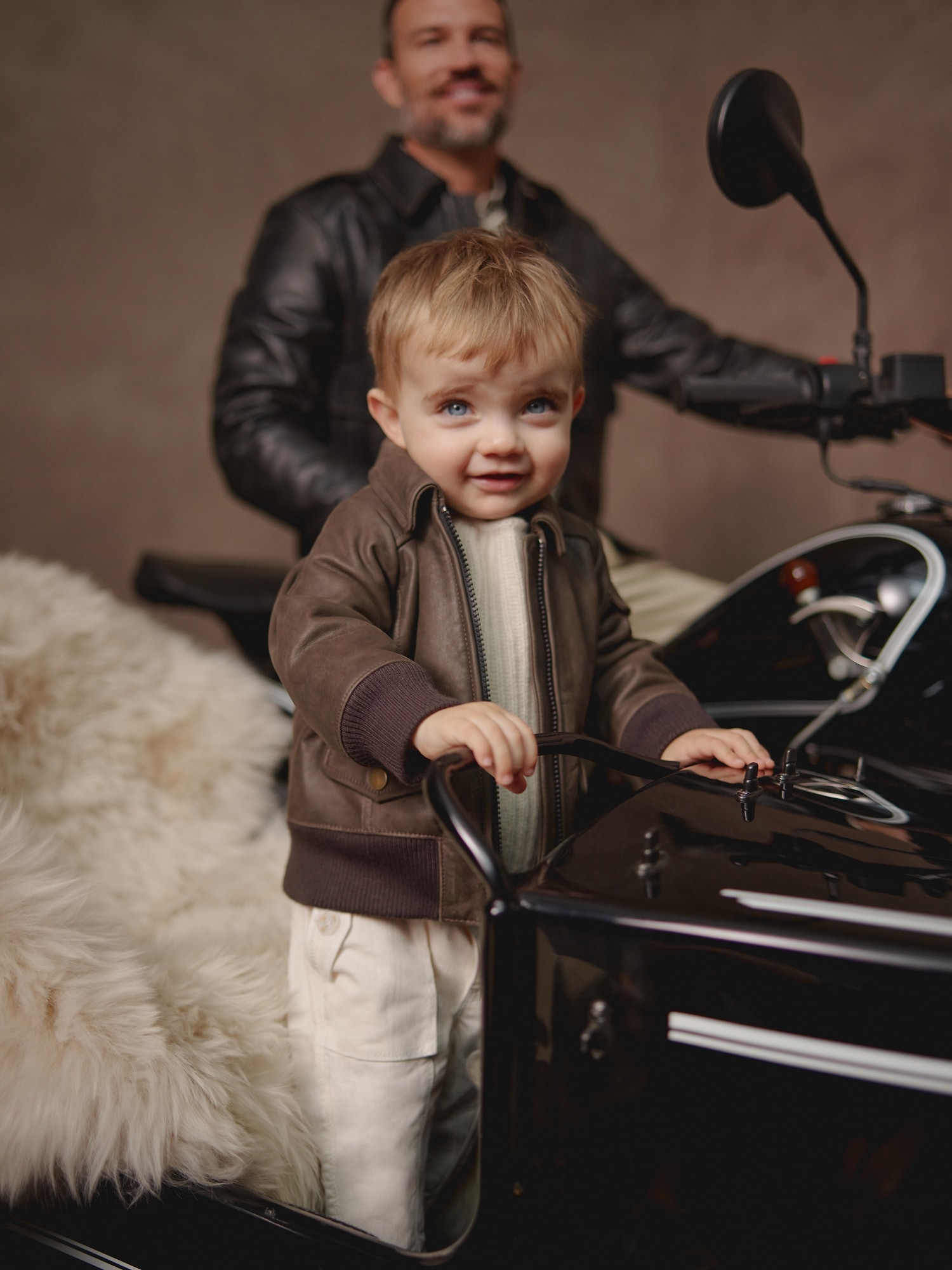 Premium AI Image | portrait of baby boy in leather jacket